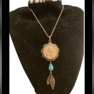 blue turquoise quarter dollar pendant hangs on a 24” gold tone necklace
